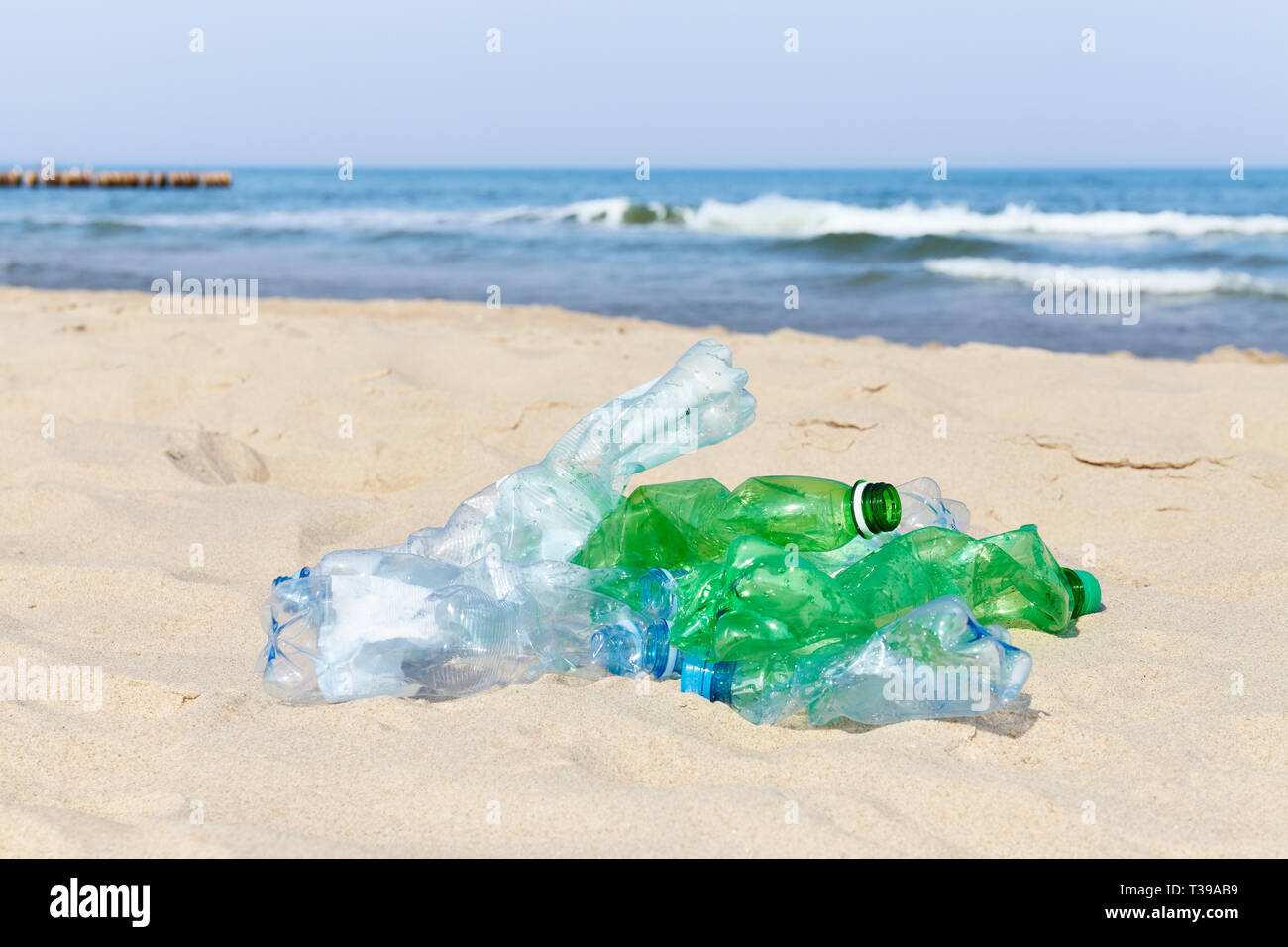 Used plastic bottles on a beach, selective focus. Stock Photo