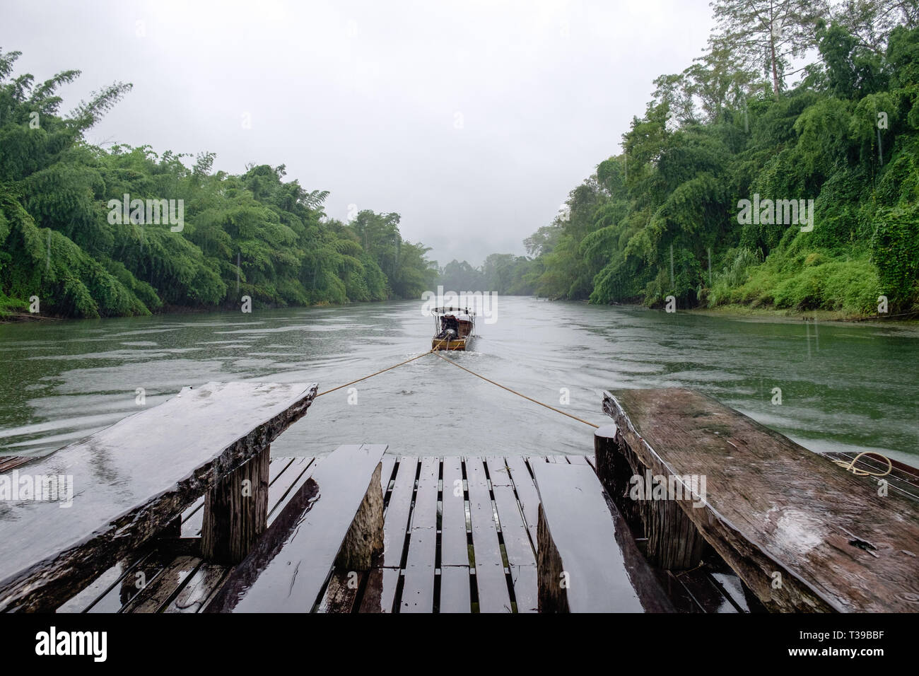 Longtail boat drag wooden raft in river kwai jungle damp Stock Photo ...