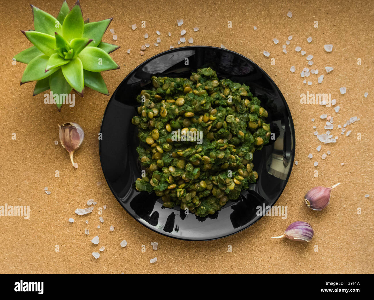 Stewed lentils with spinach. Second dish. Flat lay. The view from the top. Stock Photo