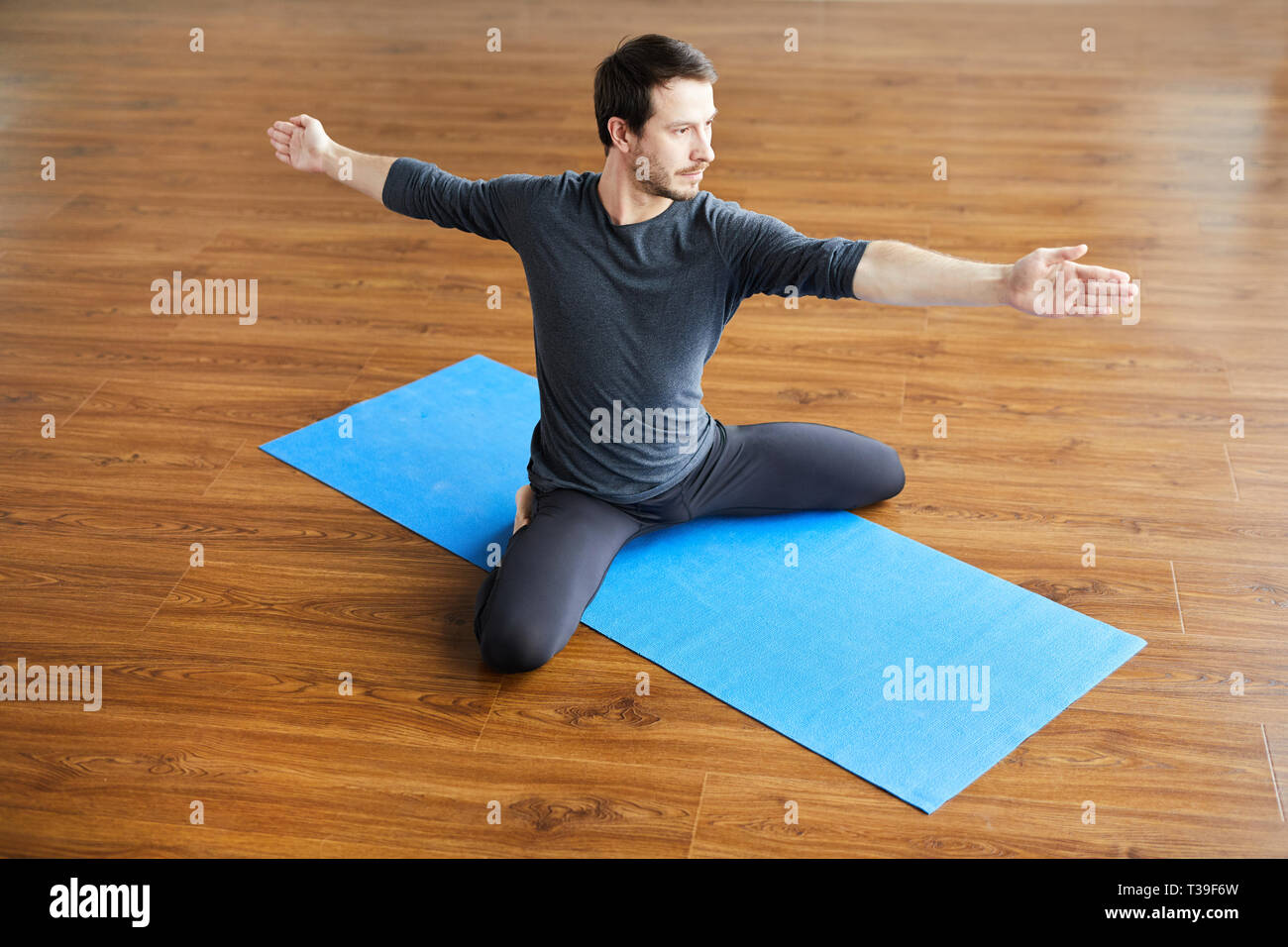 Supple man practicing yoga Stock Photo