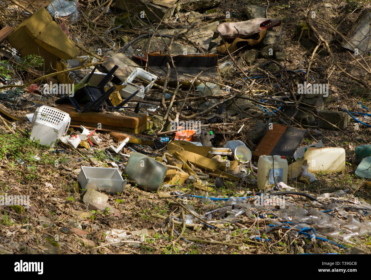 Mountain garbage in the forest. Garbage in the forest -  dump in the woods. Stock Photo