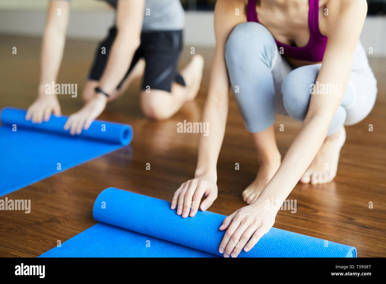 Rolling yoga mats after class Stock Photo Alamy