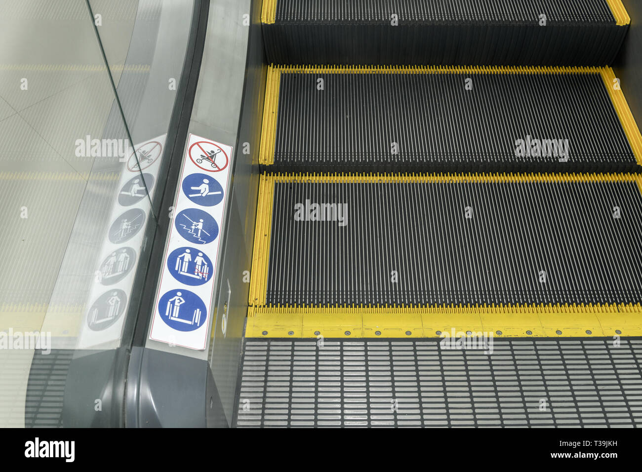 Signs on an escalator, warning signs, the escalator at the Building, safety concept Stock Photo