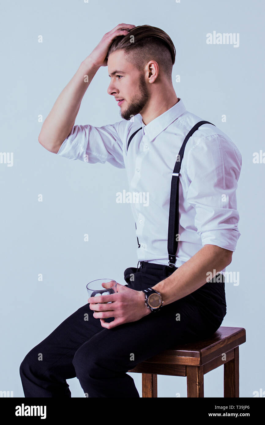 Fashionable Man In Classical Wear Keeping Hand In Hair And Glass