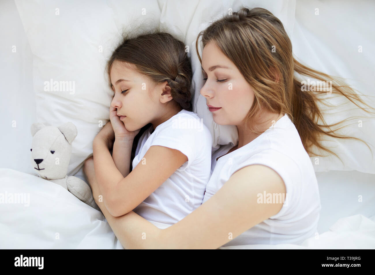 Woman Sleeping with Child Above View Stock Photo