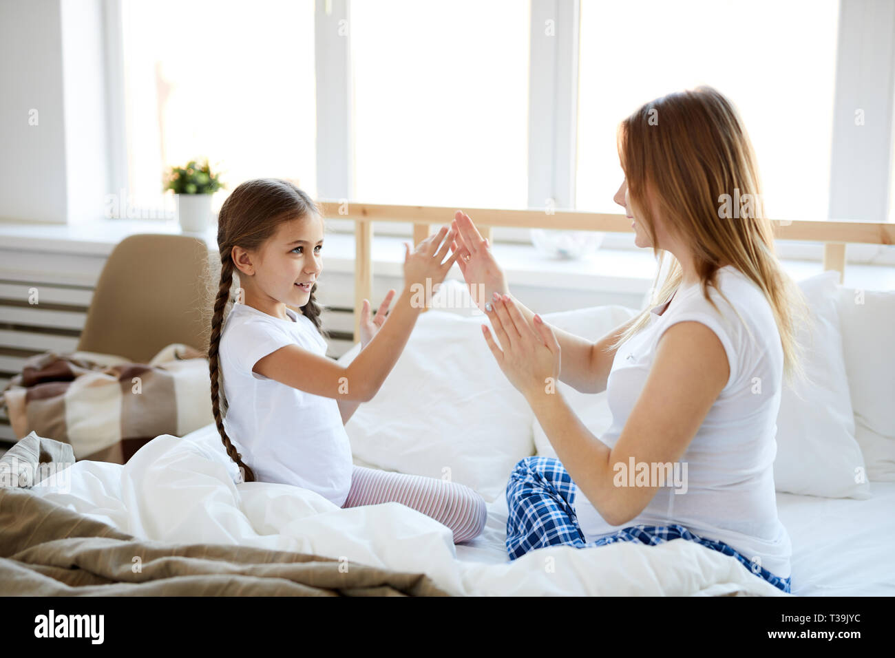 Mother and daughter Playing Hand Game Stock Photo