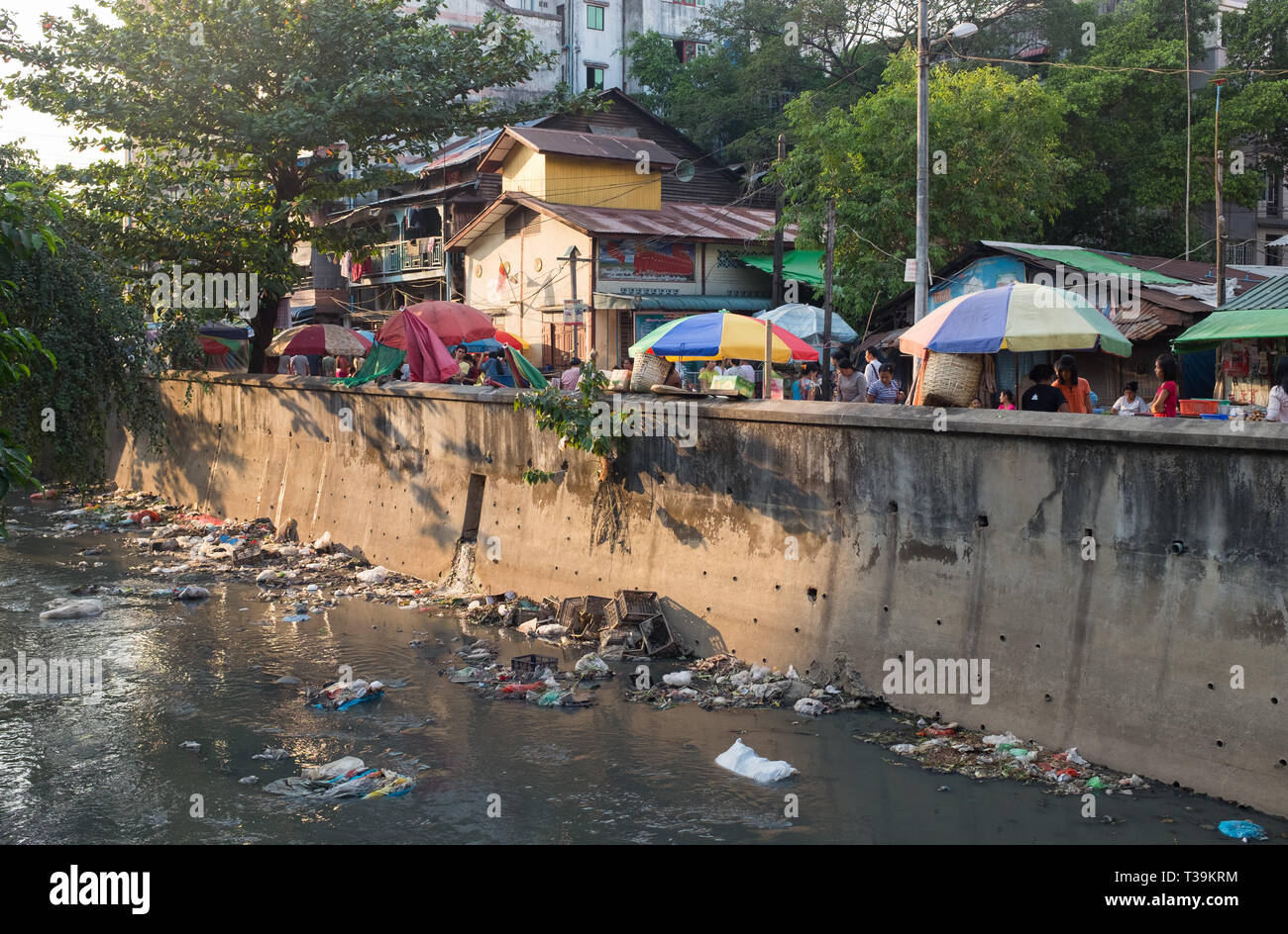 Riverbed is dirty with plastic rubbish near market in Yangon, Myanmar Stock Photo
