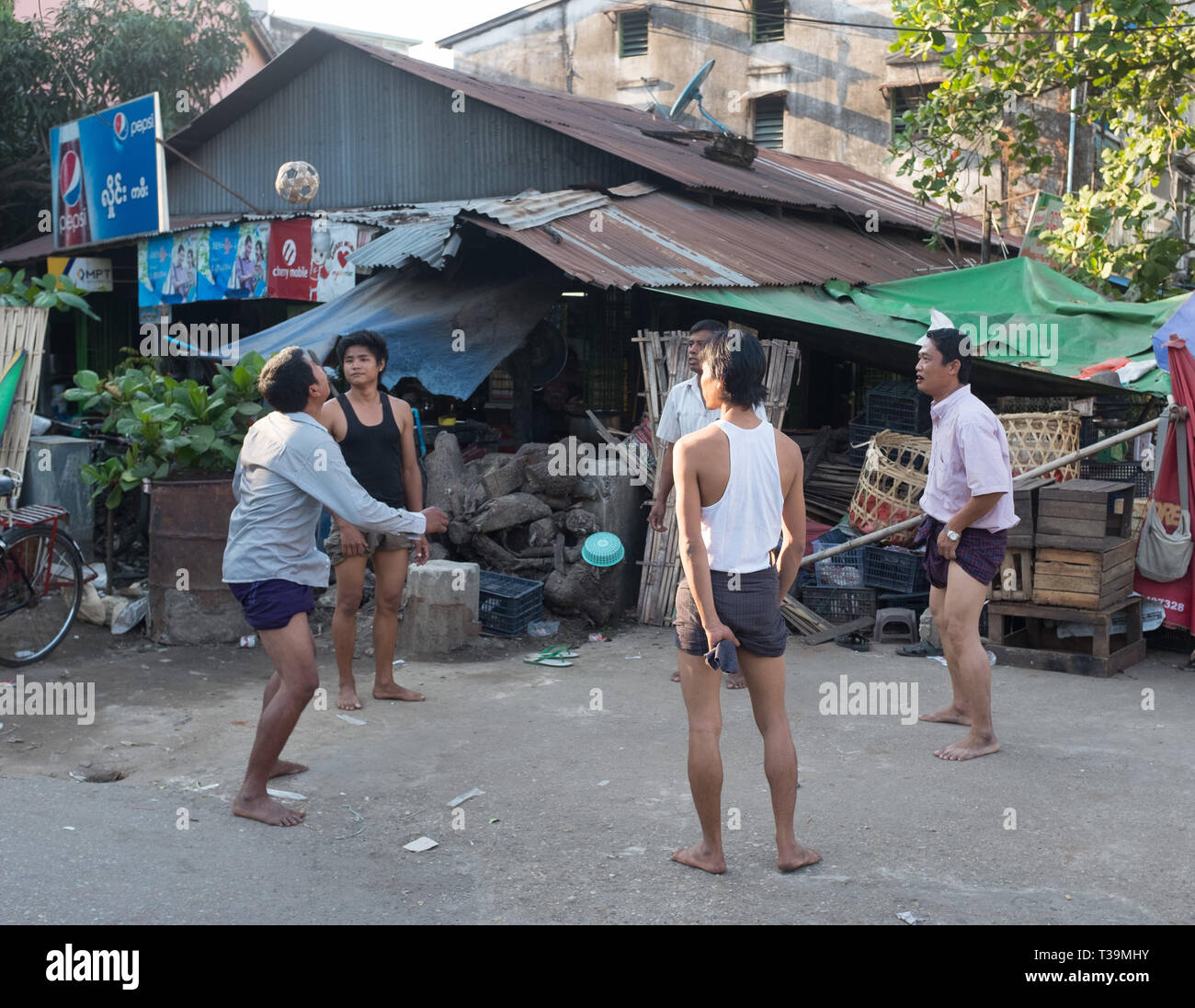 Men playing Chinlone also known as caneball, is the traditional, national sport of Myanmar (Burma). It is non-competitive, with typically six people p Stock Photo