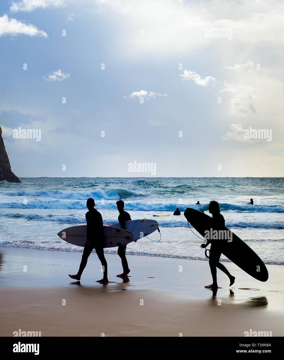 Group of surfers with surfboards on the beach. Algarve, Portugal Stock Photo