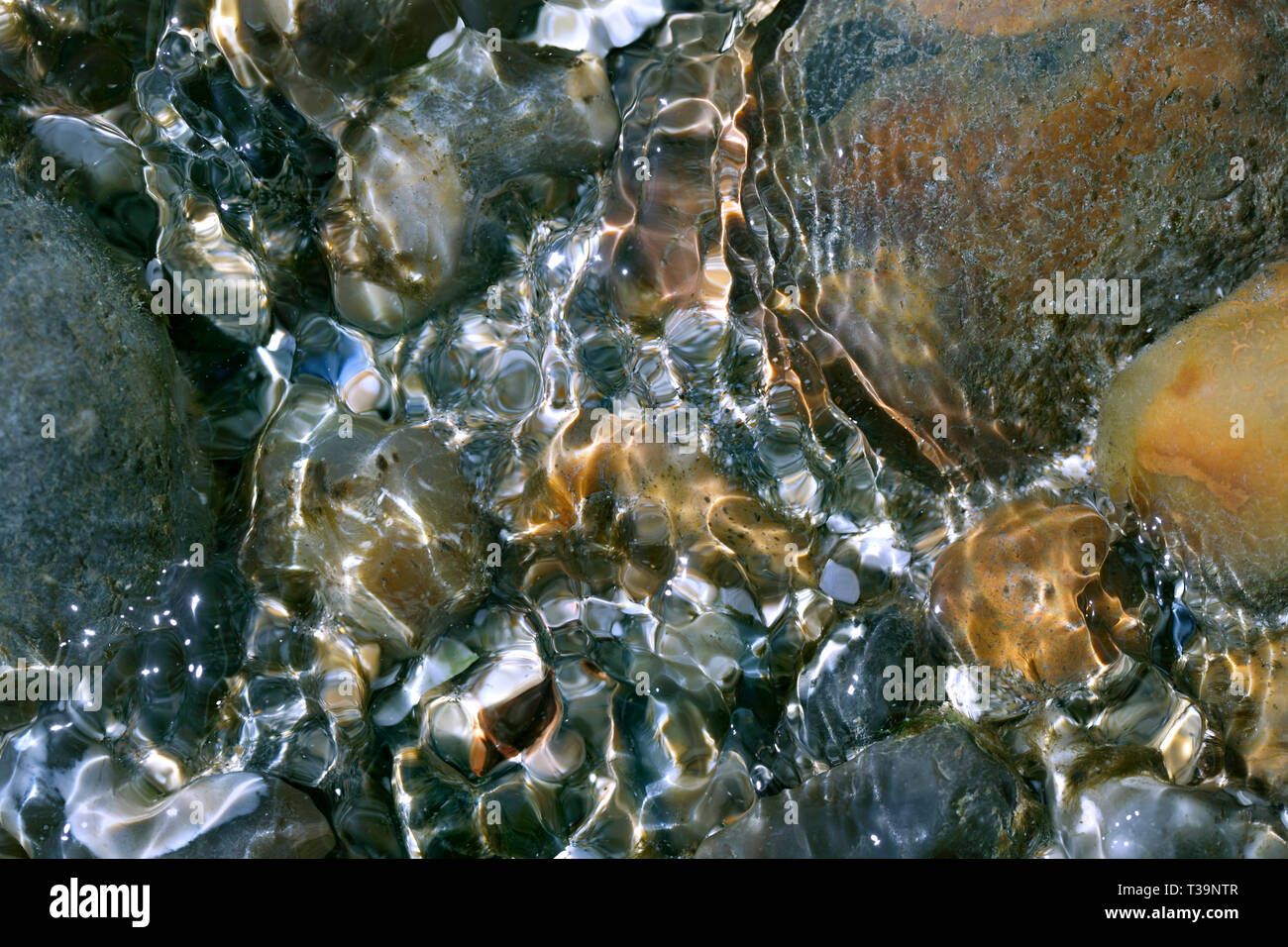 Close up of ripples of water in a rock pool on a beach, Brighton. Stock Photo