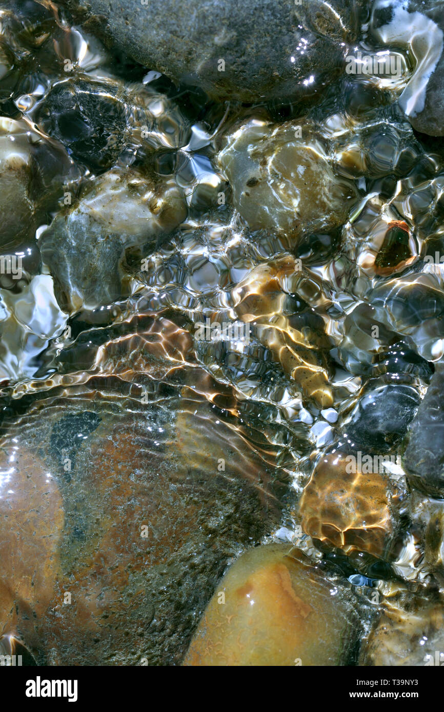 Close up of ripples of water in a rock pool on a beach, Brighton. Stock Photo