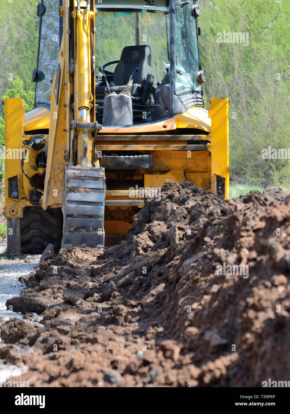 Excavator digging dirt ditch Stock Photo Alamy