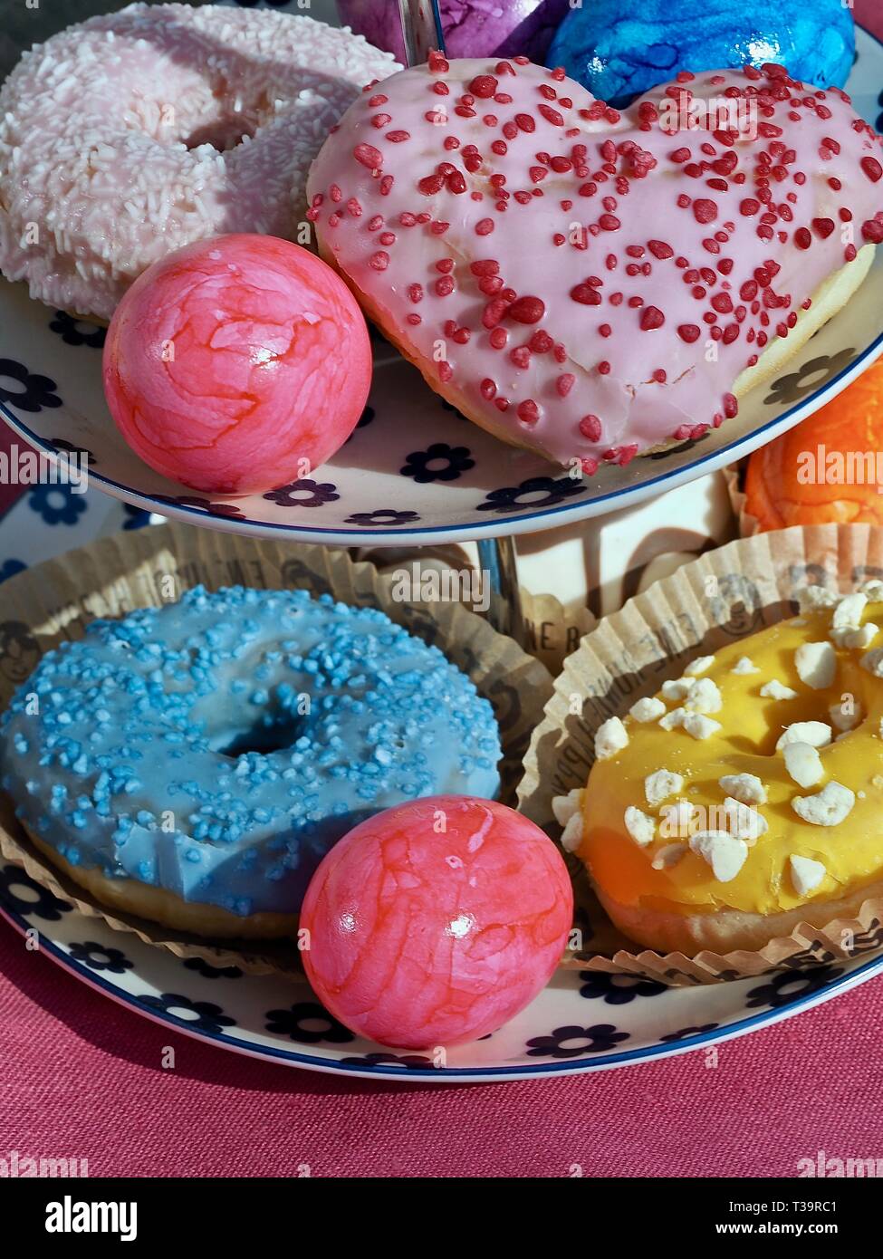 Arrangement of colorful doughnuts and easter eggs Stock Photo