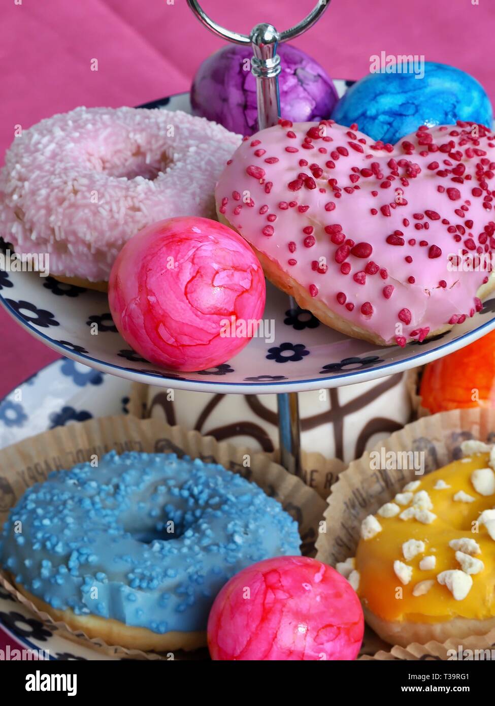Arrangement of colorful doughnuts and easter eggs Stock Photo