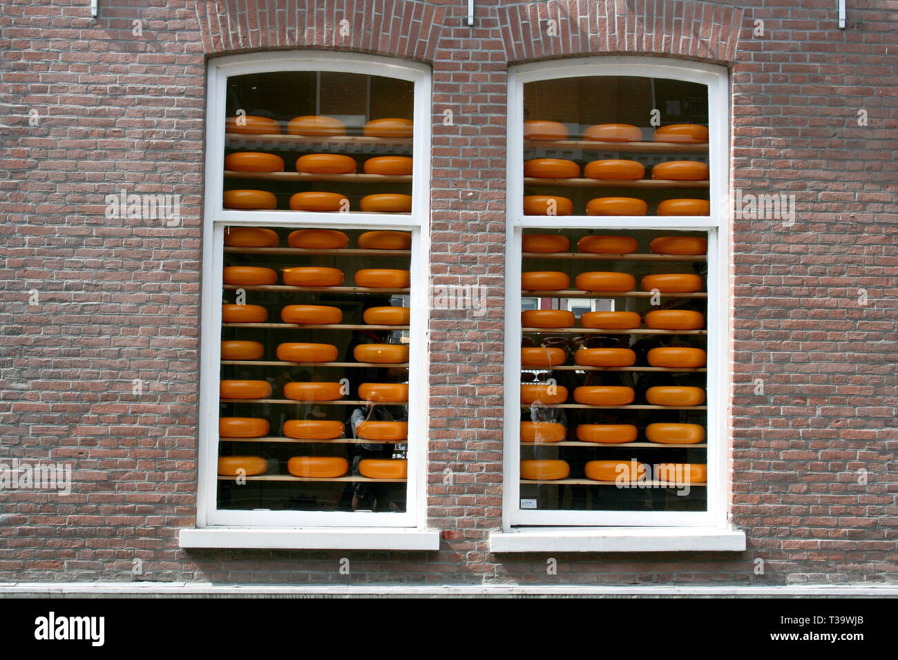 Two windows with cheeses for sale Stock Photo