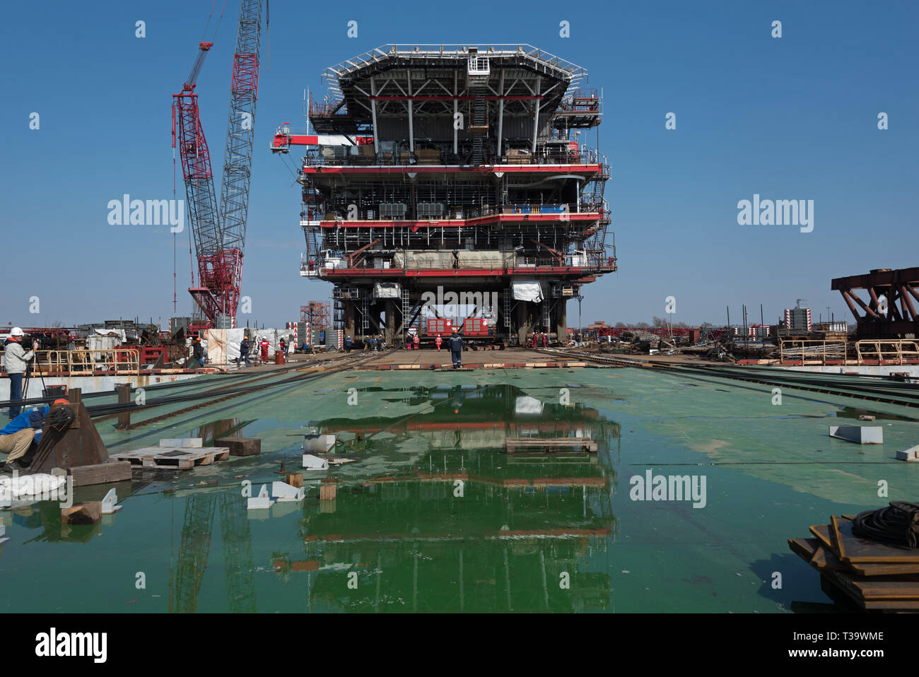 Construction and building of the wellhead of the oil rig platform for Lukoil Filanovsky field development project in the Caspian sea in Russia. Stock Photo