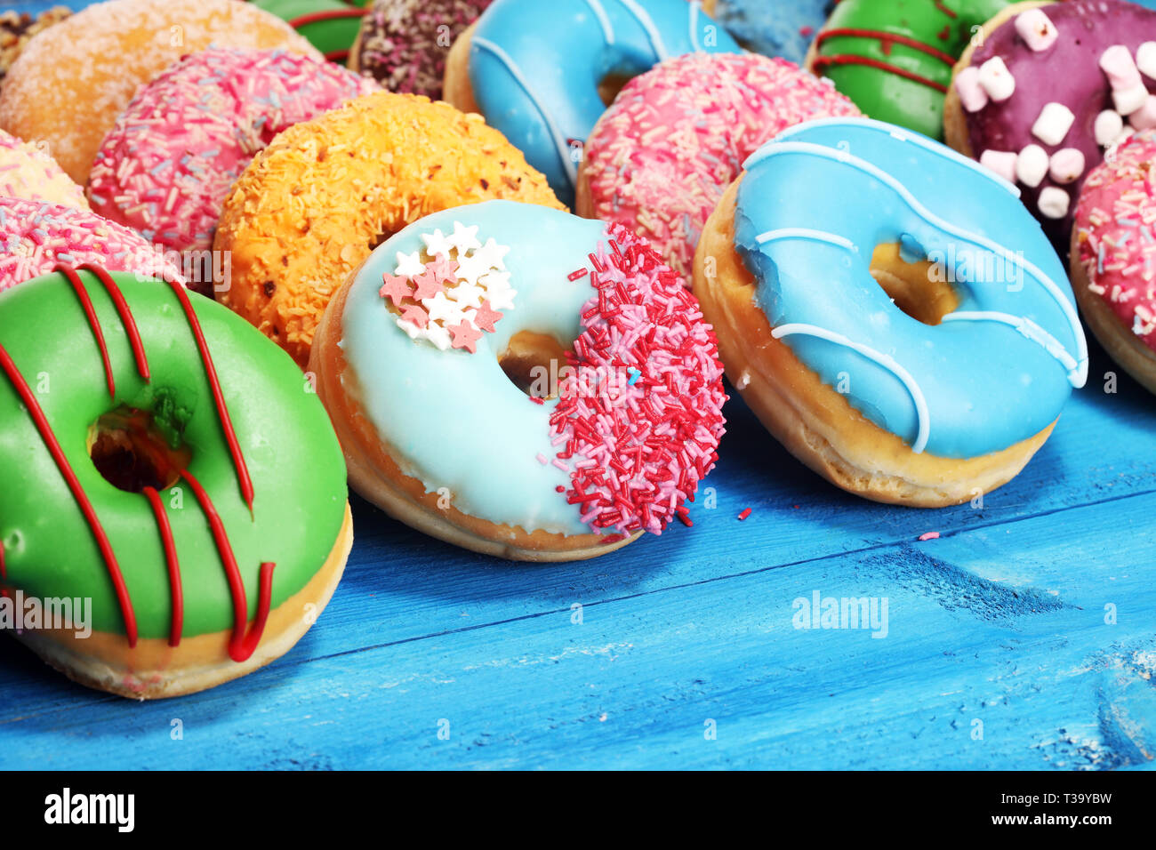 assorted donuts with chocolate frosted, pink glazed and sprinkles ...