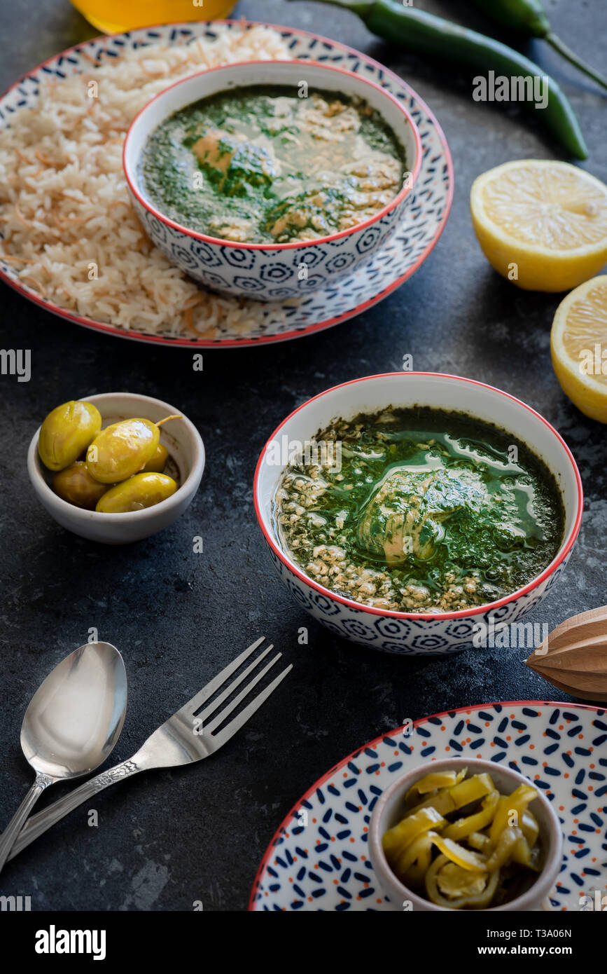molokheieh arabic palastinian traditional food in bowl with garlic and lemon Stock Photo