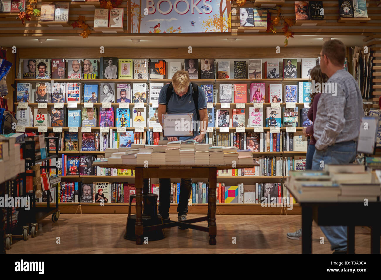 Cambridge, UK - December, 2018. Customers in a bookstore. Stock Photo