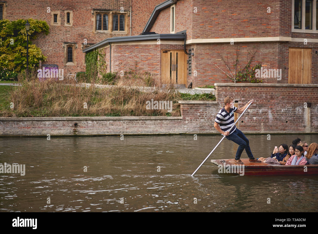 Cambridge. UK - December, 2018. Punt boats on the river Cam. Punting is very popular in Cambridge for sightseeing colleges. Stock Photo