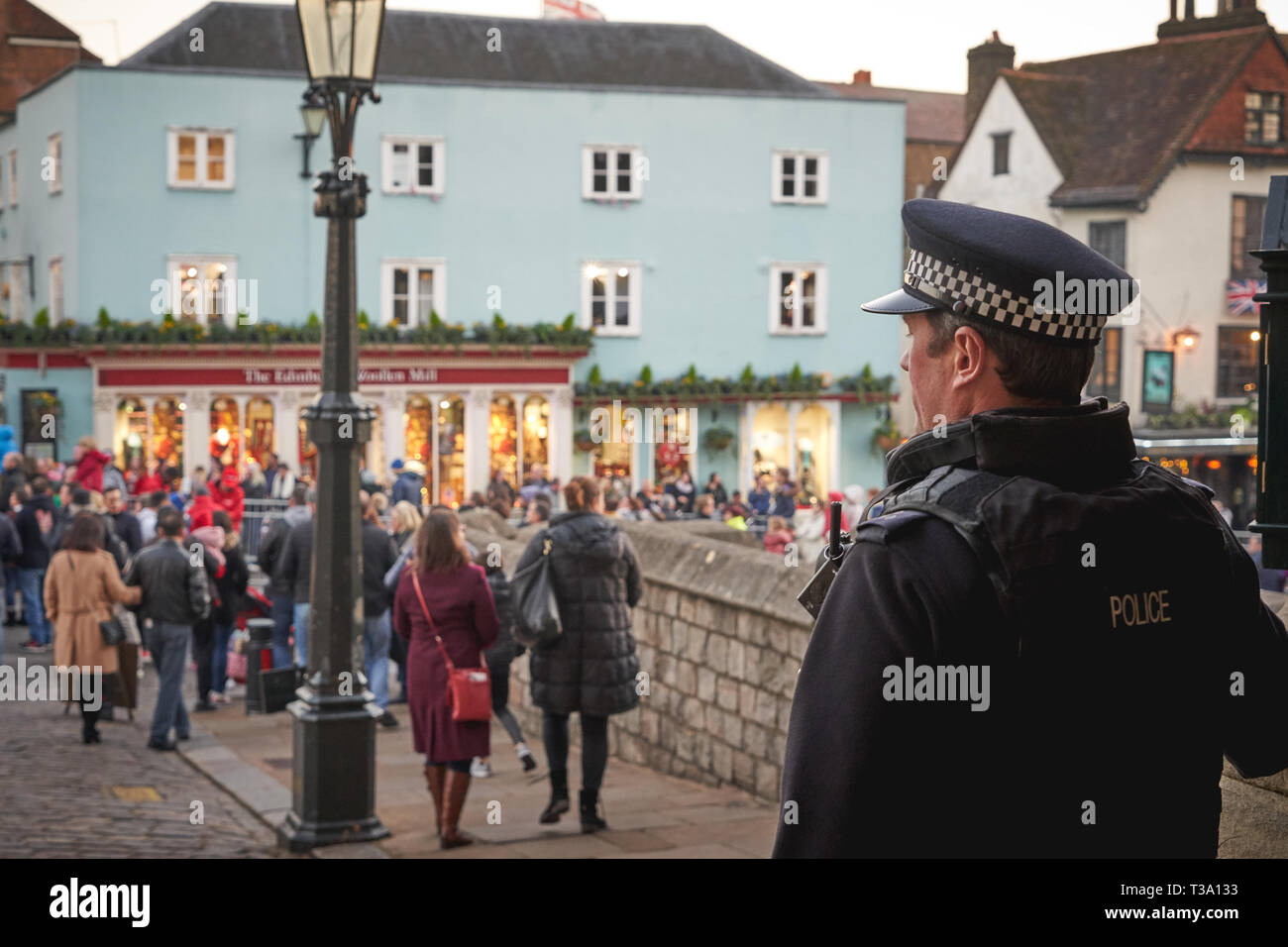 Windsor, UK - December, 2018. A police officer patrolling the street outside the Castle in Windsor. Stock Photo