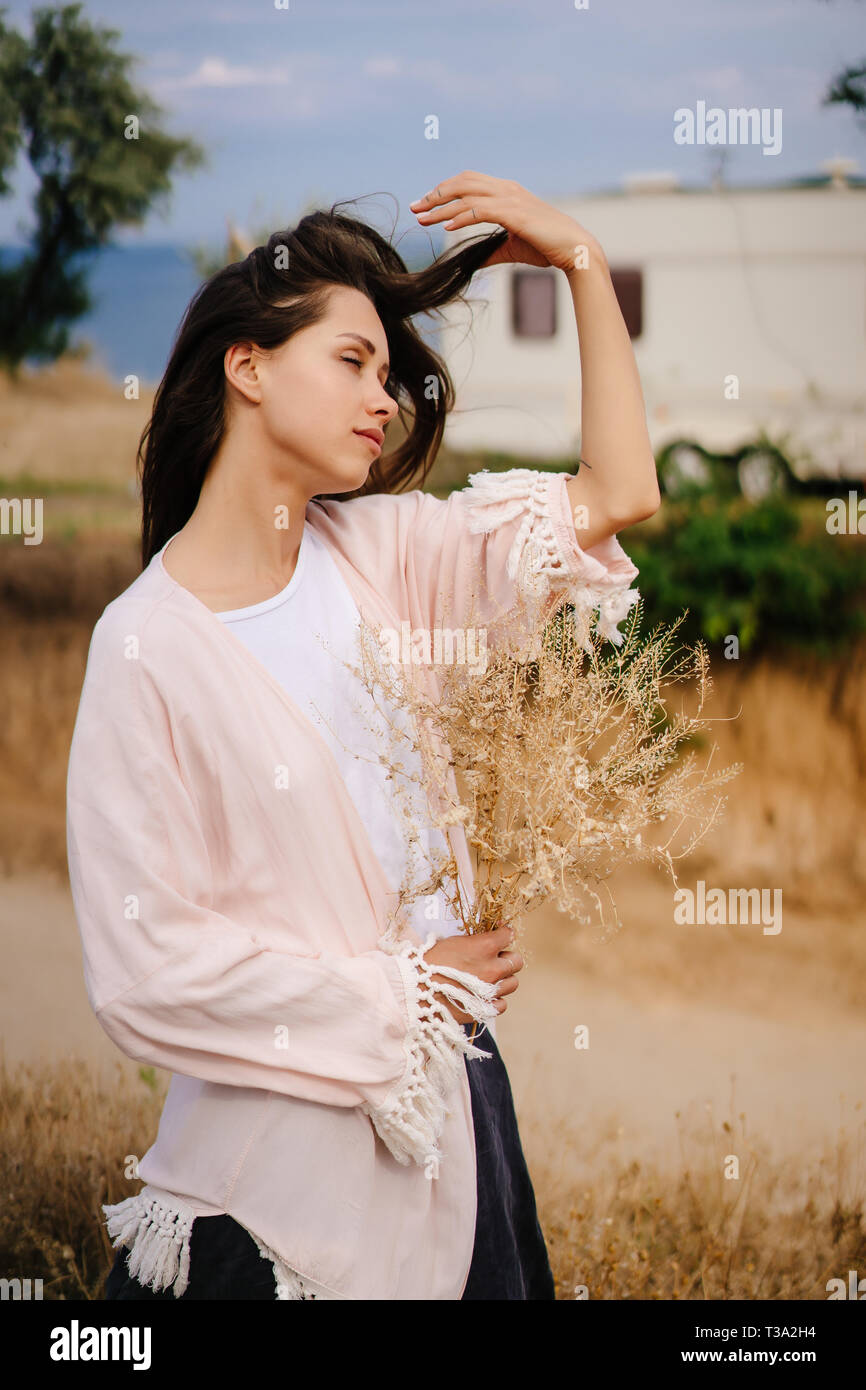 Beautiful, young girl posing on a wild seashore Stock Photo - Alamy