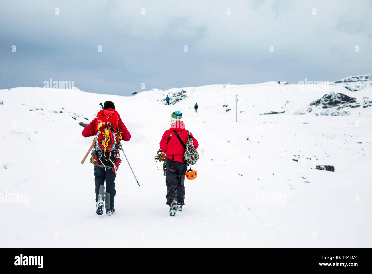 Two climbers hikers walking in the snow near Solheimajokull Glacier, Iceland Stock Photo