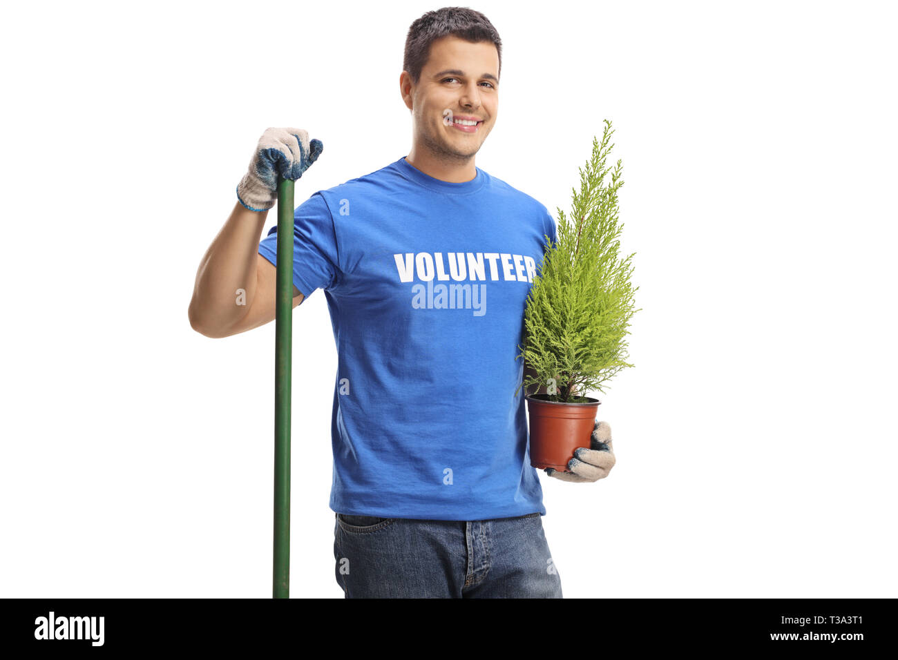 Young male volunteer with a shovel holding a plant isolated on white background Stock Photo