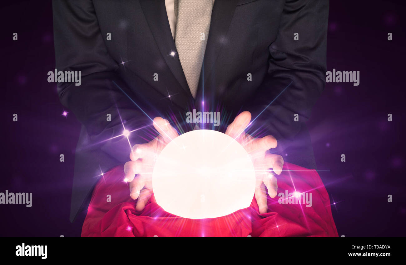 Young businessman sitting with crystal ball in action Stock Photo - Alamy