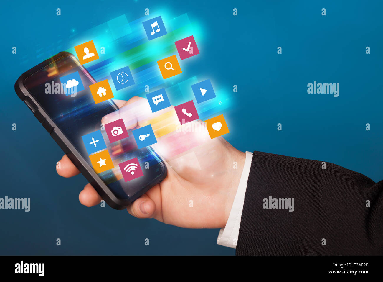 Hand using phone with colorful fast moving application icons and ...