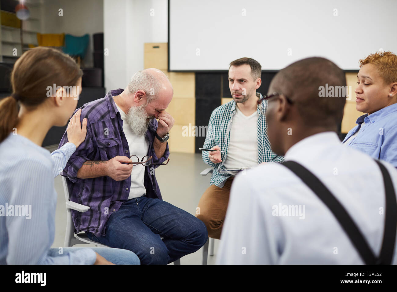 Senior Man Crying in Support Group Stock Photo