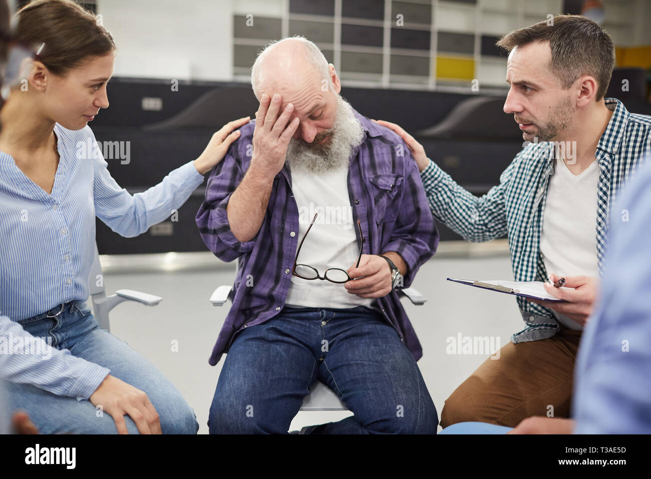 Bearded Senior Man Crying in Support Group Stock Photo