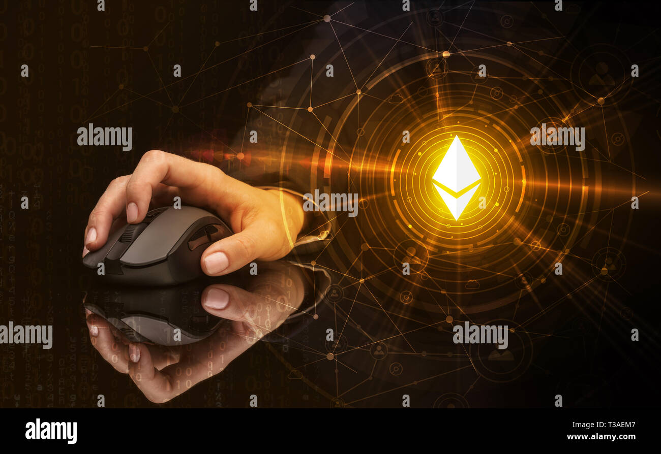 Hand using wireless mouse with cryptocurrency concept on dark ...
