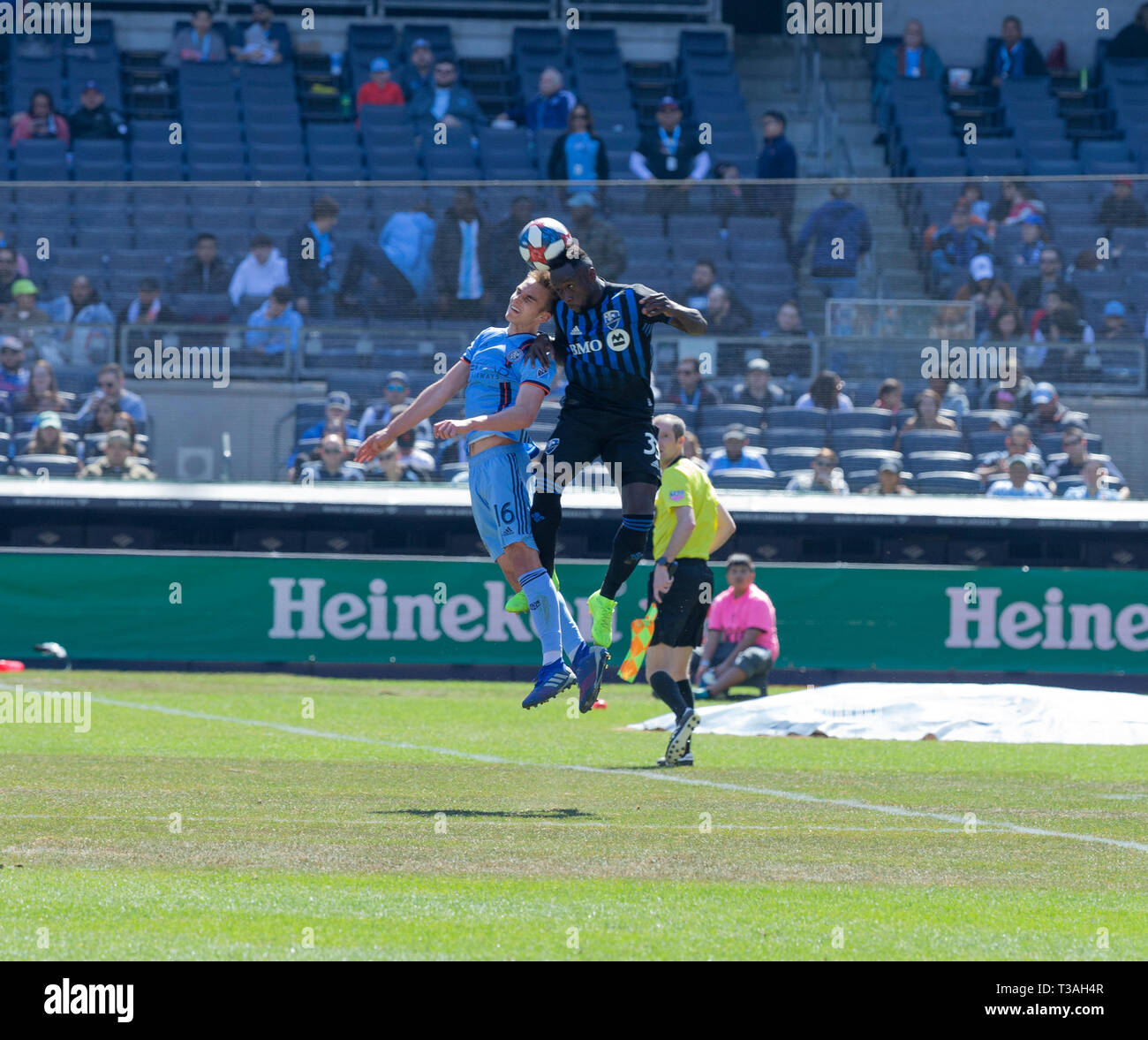 New York, NY - April 6, 2019: James Sands (16) of NYCFC and Bacary Sagna (33) of Montreal Impact fight for ball during regular MLS game at Yankee stadium Stock Photo