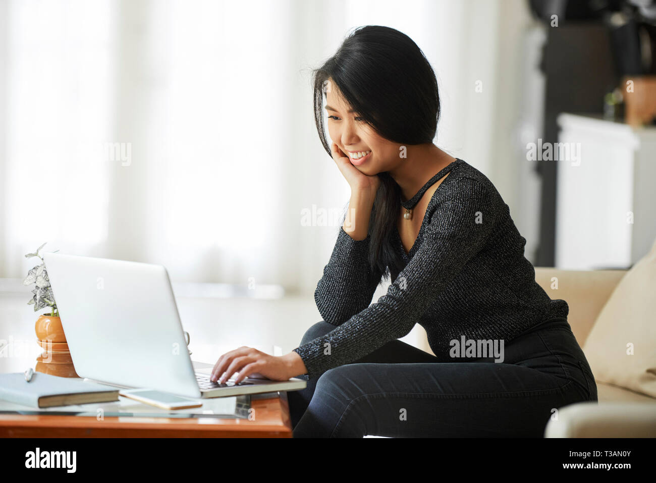 Young woman working on laptop Stock Photo