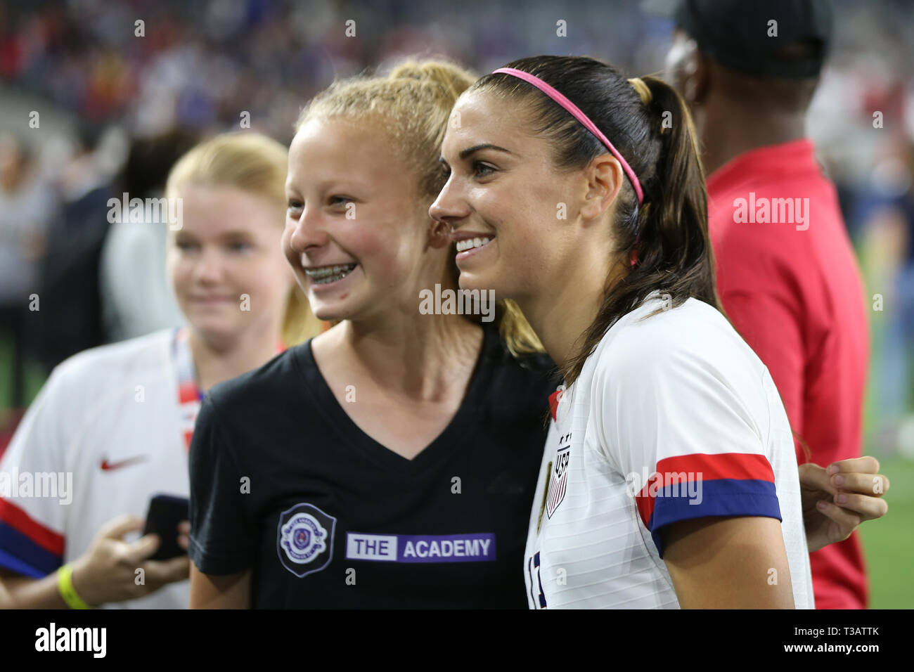 Los Angeles, CA, USA. 7th Apr, 2019. United States of America forward Alex Morgan (13) poses with a fan after the game between Belgium and USA at Banc of California Stadium in Los Angeles, CA. USA. (Photo by Peter Joneleit) Credit: csm/Alamy Live News Stock Photo