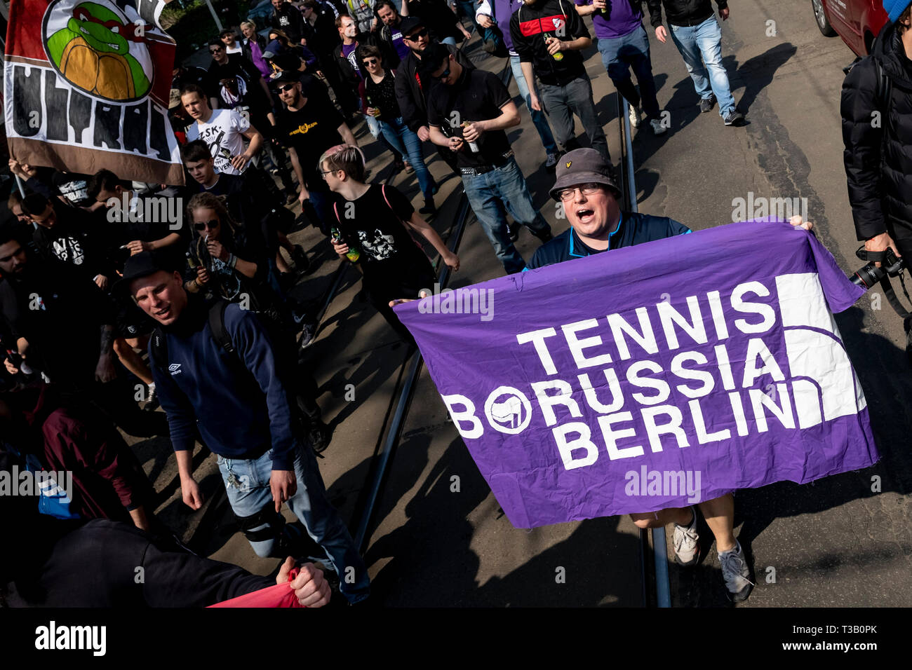 Leipzig, Germany. 07th Apr, 2019. A soccer fan of Tennis Borussia Berlin  (TeBe) is holding a TeBe banner at a fan march of Roter Stern Leipzig  before the match against VfB Zwenkau