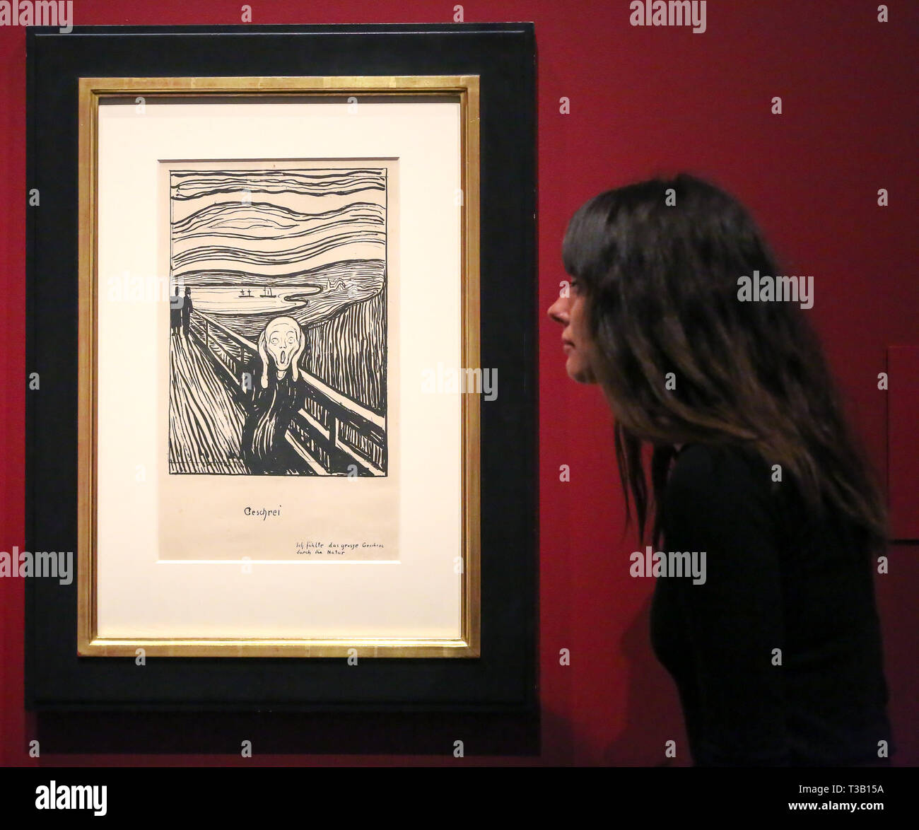 The British Museum. London, UK 8 April 2019 - A staff member views Edvard Munch's “The Scream, 1895” - which developed from an episode represented in Despair, but with the central figure turned to face the viewer. The swirling reddish-blue clouds are translated in this print into compressed undulating bands of black and white that emphasise the acute panic expressed by the figure. In a twist of fate, Munch's sister Laura was diagnosed in 1894 with schizophrenia and institutionalised in a hospital near the site of The Scream. Credit: Dinendra Haria/Alamy Live News Stock Photo