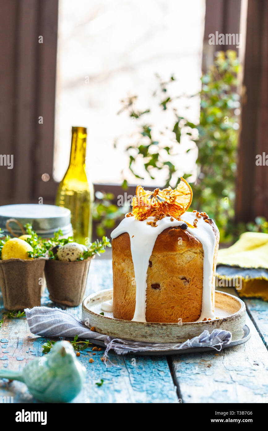 Easter cake with icing on a blue wooden table. Easter concept. Stock Photo