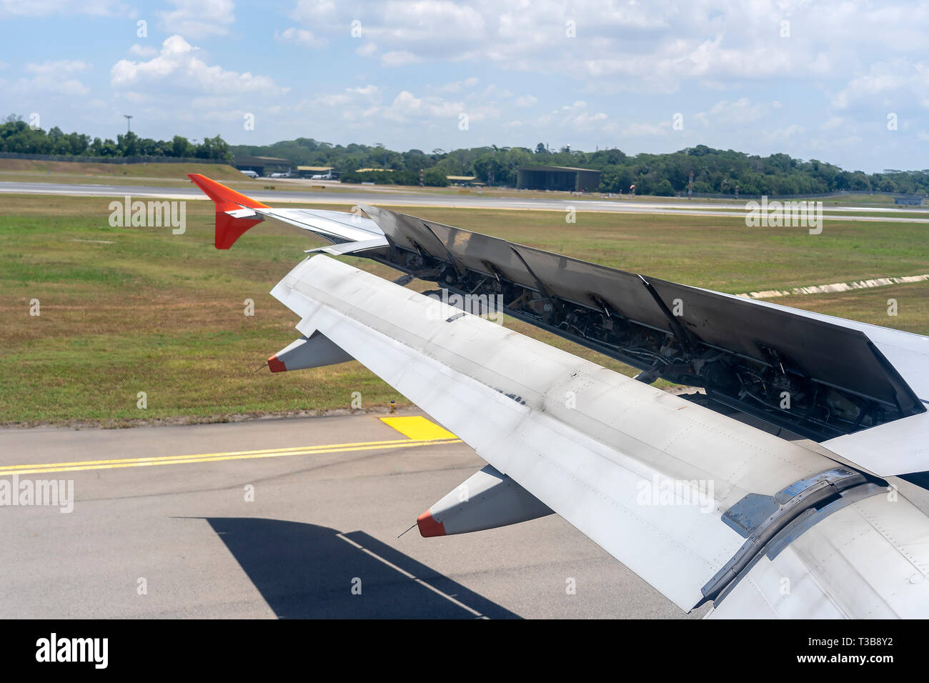 An Airplane Window View Of Wing And Flaps After Landing. Landing Aircraft  At The Airport. Braking Of The Aircraft On The Runway, Wing Of The Plane Is  Stock Photo - Alamy
