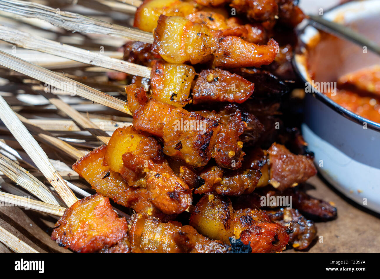 Indonesian grilled bbq meats in wooden skewers on street market, island Bali, Ubud, Indonesia