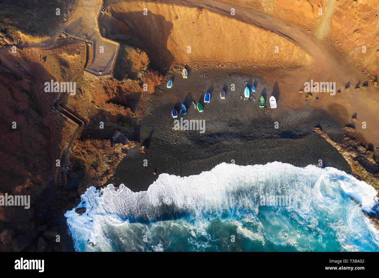 Fishing boats in bay near El Golfo, drone shot, Lanzarote, Canary Islands, Spain Stock Photo