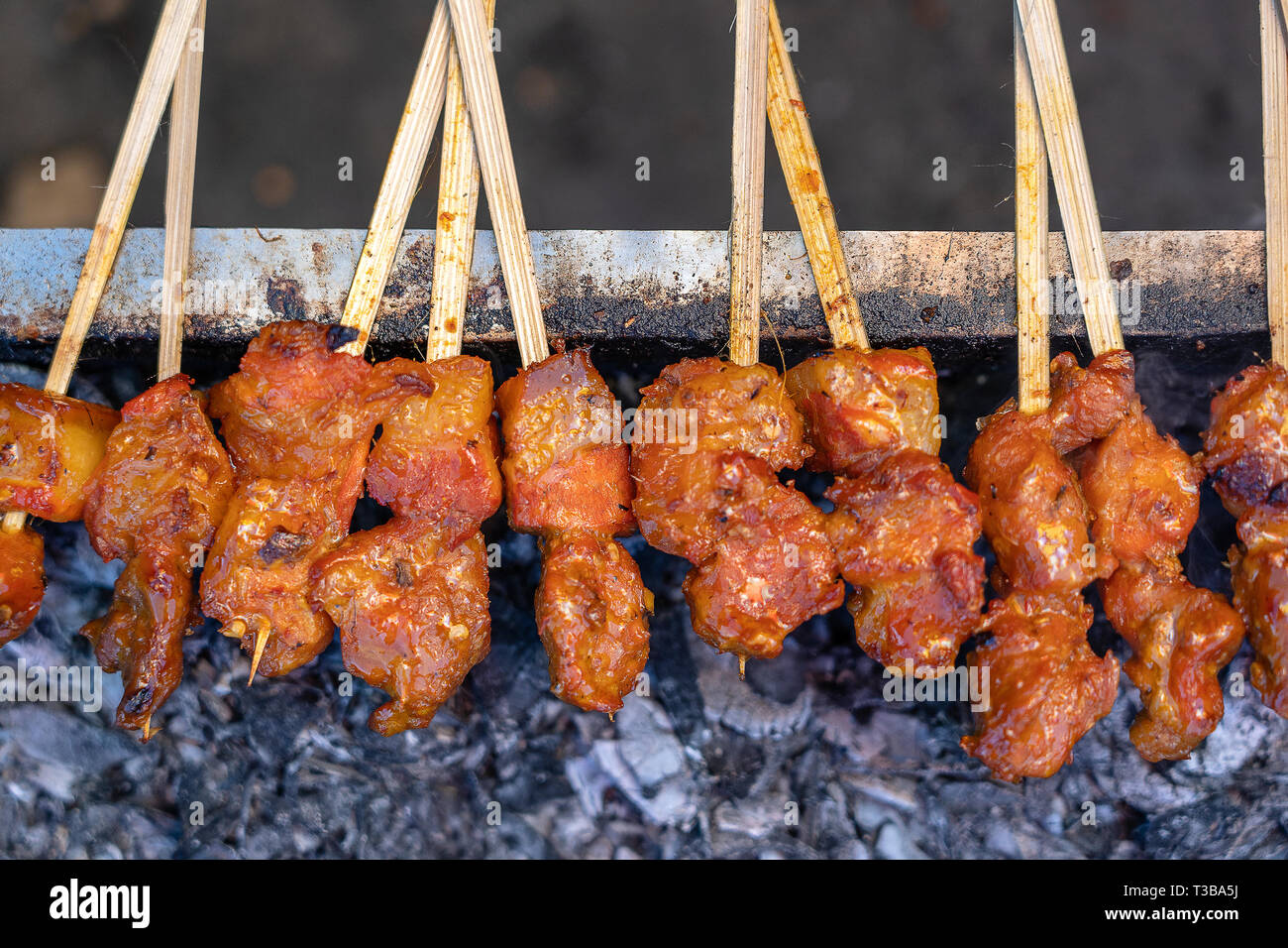Indonesian grilled bbq meats in wooden skewers on street market, island Bali, Ubud, Indonesia