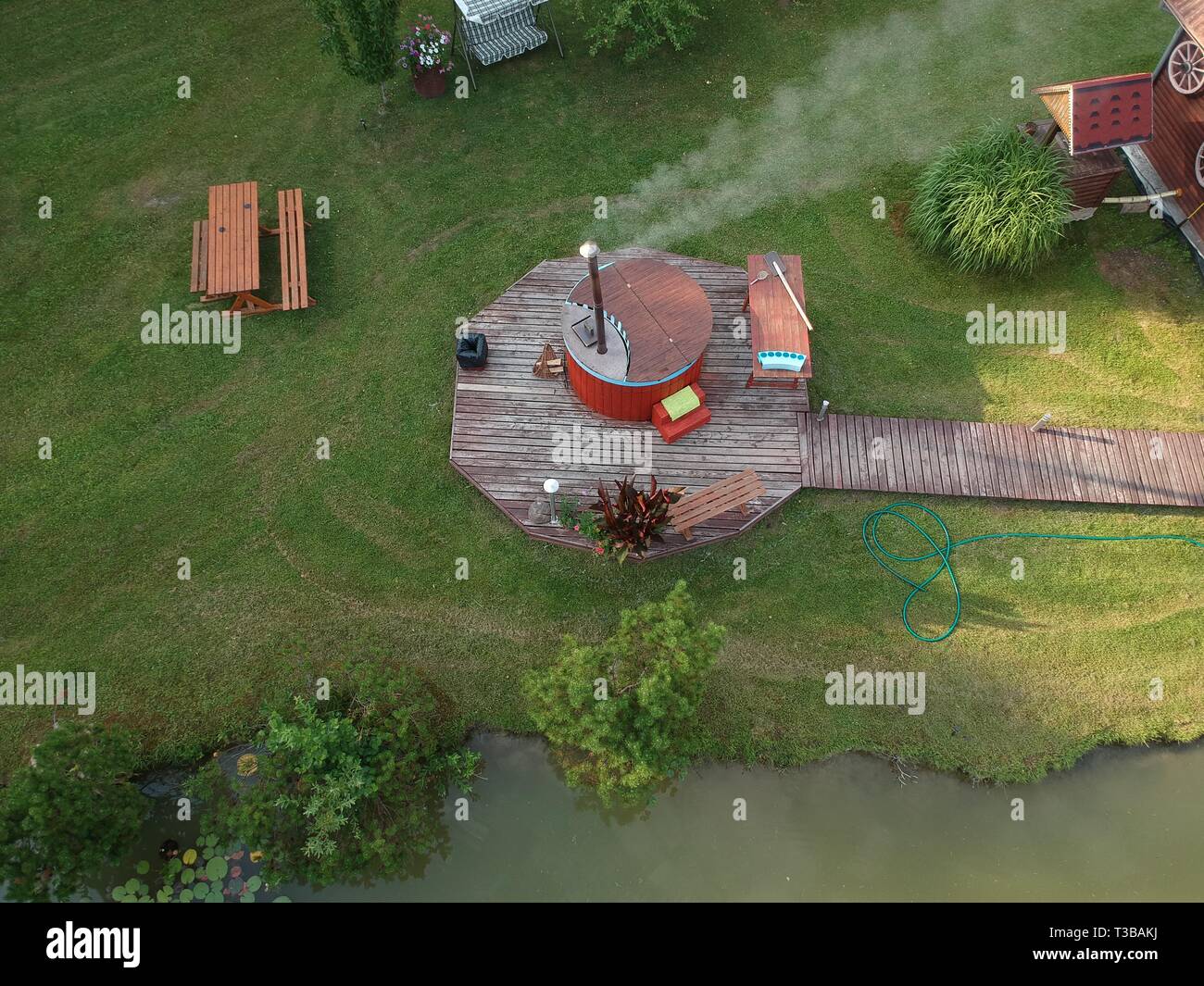 outdoor wooden barrel bath in summer homestead, aerial view Stock Photo