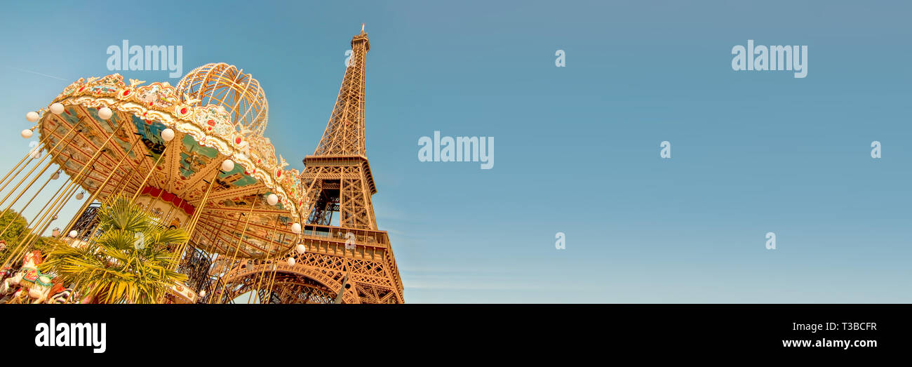 Vintage carousel and the Eiffel tower, Paris France panoramic background with copy space Stock Photo