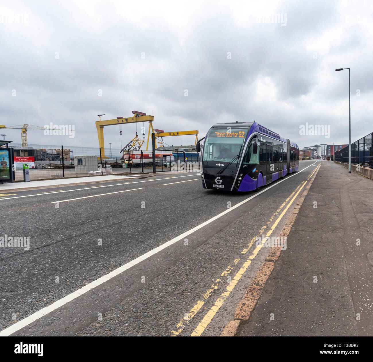 Belfast Glider bus. Modern sleek "bendy bus" as public transport passing Titanic Studios