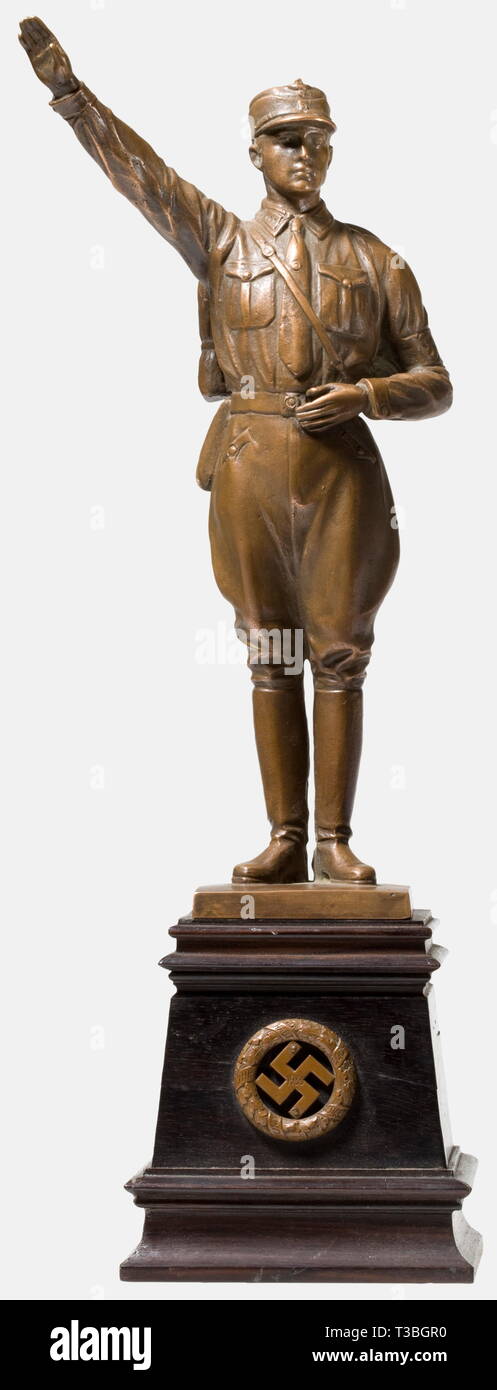 Josef Schuster, a bronze figure of an SA man A saluting SA man with knapsack, bronze with brown patina. Mounted on a black wooden base, on the obverse an applied swastika dated '1933' within an oak leaf wreath with the scroll 'Und ihr habt doch gesiegt' ('And still you were victorious'). Remnants of an old label on the bottom 'RM...'. Total height 37 cm. historic, historical, people, 1930s, 20th century, storm battalion, stormtroopers, armed and uniformed branch of the NSDAP, organisation, organization, organizations, organisations, NS, National Socialism, Nazism, Third Rei, Editorial-Use-Only Stock Photo