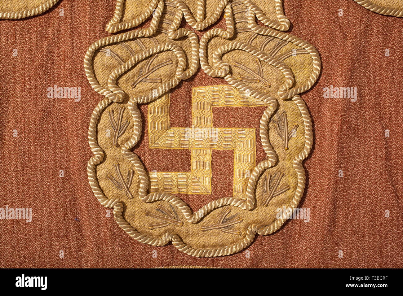 A decorative hanging for a parade float, in the procession '2000 Years of German Culture' in Munich 1938 Heavy cotton interwoven with gold and bearing an applied, gold coloured national eagle emblem outlined with gold cord on an oak leaf wreath. The swastika applied with gold braid, meander bordering on the sides. Forged iron suspension rings probably of later date. 130 x 215 cm. Probably a parade float banner of the 'Neue Zeit' ('New Era'). Cf. other decorative hangings of this kind in '2000 Jahre Deutsche Kultur', Bayerland Verlag, Munich 1938, p. 31 and in 'Festtage in M, Editorial-Use-Only Stock Photo