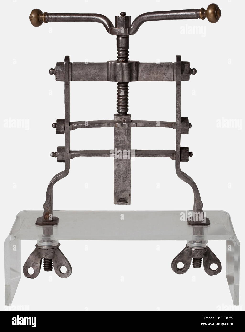 A large French seal press, circa 1700 Heavy frame of forged iron bars bolted together with nuts. Central vertical threaded rod, the handle bar with spherical brass finials. The lower end of the ram fitted with a receiver for signets with retaining screw. At the bottom ends of the frame two stud bolts with large thumb nuts for table top mounting. Mounted on a modern acrylic glass stand. Height 51 cm, width 42 cm. historic, historical, 18th century, handicrafts, handcraft, craft, object, objects, stills, clipping, clippings, cut out, cut-out, cut-o, Additional-Rights-Clearance-Info-Not-Available Stock Photo