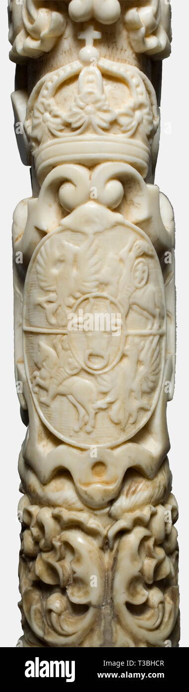 A splendid Polish powder horn, 1st half of the 19th century. A finely carved horn of walrus(?) ivory in the baroque style. Both sides display hunting scenes in half relief, showing hounds fighting with a boar and with wolves, above a hunting trophy bundle or the crowned coat of arms for Poland/Lithuania. Nozzle carved in the shape of a wild boar's head. Silver suspension chain, bands bearing the Russian hallmark '84'. Restored break at the lower end. Length 40 cm. historic, historical, 19th century, powder flask, accessory, accessories, military,, Additional-Rights-Clearance-Info-Not-Available Stock Photo